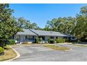 Well-maintained townhome exterior showcasing neat landscaping and ample parking space at 2723 Beacon St, Eustis, FL 32726