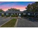 Dusk view of townhome featuring serene surroundings, lush bushes, and designated parking at 2723 Beacon St, Eustis, FL 32726