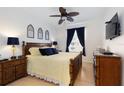 Comfortable main bedroom features a ceiling fan, window with curtains, and stylish decor at 2784 Almaton Loop # 301, Kissimmee, FL 34747