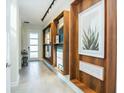 Inviting hallway featuring stylish decor, unique wall shelves, and neutral tile flooring at 2807 Bookmark Dr, Kissimmee, FL 34746