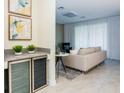 Open living space with a cozy seating area, modern mini bar, and lots of natural light at 2807 Bookmark Dr, Kissimmee, FL 34746