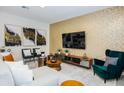 Bright living room with modern decor, accent wall, and comfortable seating arrangement at 2807 Bookmark Dr, Kissimmee, FL 34746