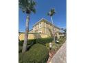 Two-story townhome with lush landscaping and mature palm trees at 3026 Bella Vista Dr, Davenport, FL 33897