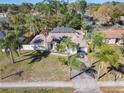 Expansive aerial view of a home with a screened-in pool, fenced yard, and mature landscaping at 3252 Noah St, Deltona, FL 32738