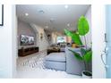 Inviting living room boasts natural light, contemporary decor, and a comfortable seating arrangement for relaxation and entertainment at 3428 Lilac Way, Davenport, FL 33897