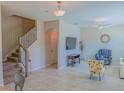 Spacious living room featuring tile floors, neutral paint, ceiling fan, and a staircase at 3593 Brighton Park Cir, Belle Isle, FL 32812