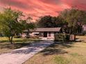 Charming one-story brick home with a well-maintained lawn and a long driveway at 46 Smyrna Dr, Debary, FL 32713