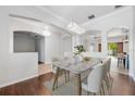 Bright dining room featuring modern chandelier and view into living spaces at 5055 Coveview Dr, St Cloud, FL 34771