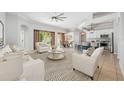 Open concept living room with dining and kitchen areas featuring neutral color palette at 5055 Coveview Dr, St Cloud, FL 34771
