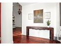 Inviting entryway featuring hardwood floors, a decorative table, and elegant wall decor at 6120 Payne Stewart Dr, Windermere, FL 34786