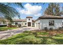 Charming single-story home with a red tile roof, attached garage, and a brick driveway at 6120 Payne Stewart Dr, Windermere, FL 34786