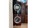 Convenient laundry area featuring stacked washer and dryer units and ample cabinet space at 655 Katherine Ave, Orlando, FL 32810