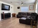 Cozy living room featuring a plush brown leather sectional and sleek entertainment center at 655 Katherine Ave, Orlando, FL 32810