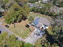 Aerial view of a well-maintained home, surrounded by lush trees and landscaping at 709 S Parsons Ave, Deland, FL 32720