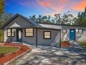 Stylish single-story home featuring two entry doors and a well-maintained front yard at 709 S Parsons Ave, Deland, FL 32720