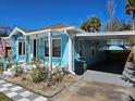 Bright blue home with a covered carport and well-maintained landscaping at 723 Dougherty St, New Smyrna Beach, FL 32168
