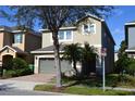Two-story house with neutral stucco, and well-maintained lawn and landscaping at 7609 Brookhurst Ln, Kissimmee, FL 34747