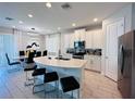 Modern kitchen with a large island, stainless steel appliances, and ample cabinet space for storage at 7719 Graben St, Kissimmee, FL 34747