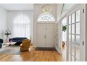 Bright foyer showcases soaring ceilings, hardwood floors, and grand double doors at 824 Palm Cove Dr, Orlando, FL 32835