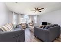 Inviting living room with hardwood floors, comfortable sofas, a ceiling fan, and ample natural light at 8711 Rockingham Ter # A, Kissimmee, FL 34747
