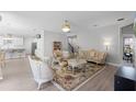 Cozy living room with ornate furniture, a large rug, and easy access to the kitchen and stairs at 965 Talon Pl, Winter Springs, FL 32708