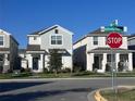 Charming street view featuring well-maintained homes with manicured lawns and clear blue skies at 9787 Introduction Way, Orlando, FL 32832