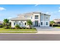 Beautiful two-story home showcasing a modern design, well-manicured lawn, and a paved driveway at 10032 Brocksport Cir, Gotha, FL 34734