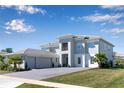 Stately home features a spacious three-car garage, lush lawn, and inviting facade with ample parking at 10032 Brocksport Cir, Gotha, FL 34734
