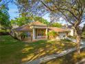A pleasing angle of this home's exterior showing lawn, landscaping and mature trees at 1187 Tadsworth Ter, Lake Mary, FL 32746