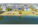 Waterfront homes with backyard pools and lush landscaping line a scenic walking path at 13059 Stoddart Ave, Orlando, FL 32827