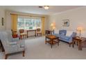 Traditional living room with large windows providing abundant natural light, carpet floors and neutral walls at 1322 Ensenada Dr, Orlando, FL 32825