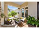 A cozy covered patio with brick pavers and comfortable seating is perfect for outdoor relaxing at 13346 Alderley Dr, Orlando, FL 32832