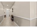 View of the hallway featuring neutral paint tones and a decorative console table at 14500 Black Quill Dr, Winter Garden, FL 34787