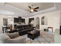 Open-concept living room and kitchen area with dark cabinets and neutral walls at 14500 Black Quill Dr, Winter Garden, FL 34787