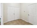 Neutral entryway with double doors, tile floor, and a closet at 1549 Balsam Willow Trl, Orlando, FL 32825