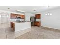 Open kitchen featuring stainless steel appliances, granite countertops, and a breakfast bar at 16140 Yelloweyed Dr, Clermont, FL 34714