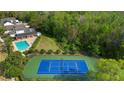 Aerial view of the community pool, tennis court, and surrounding green space at 1669 Slash Pine Pl, Oviedo, FL 32765