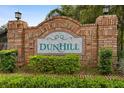 Community entrance sign for Dunhill, surrounded by lush landscaping at 1669 Slash Pine Pl, Oviedo, FL 32765
