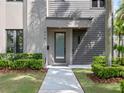 Close-up of the home's entrance, showcasing the walkway and professionally maintained landscaping at 1970 Laurel Rd, Winter Park, FL 32789