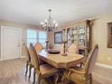 An elegant formal dining room with a decorative chandelier, hutch, and seating for six at 2055 S Atlantic Ave # 1604, Daytona Beach, FL 32118