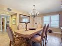 Dining room area with an ornate wooden table, six chairs, and stylish decor at 2055 S Atlantic Ave # 1604, Daytona Beach, FL 32118