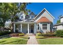 Beautiful two story home with a well maintained lawn, lovely landscaping, inviting front porch and a brick walkway at 2109 E Central Blvd, Orlando, FL 32803