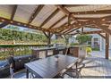 Outdoor kitchen featuring a grill, refrigerator, dining table and backyard view at 2109 E Central Blvd, Orlando, FL 32803