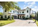 Beautiful two-story home featuring a basketball hoop and lush landscaping at 2536 Brookshire Ave, Winter Park, FL 32792