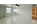 Bright bedroom featuring tile floors, a ceiling fan with lighting, and natural light from two windows at 2751 L B Mcleod Rd # 2751, Orlando, FL 32805