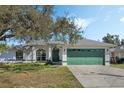 Single-story home with a two-car garage, arched windows, and a well-maintained front lawn at 3275 Deer Lick Ct, Kissimmee, FL 34746