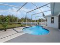 Sparkling in-ground pool with a screened enclosure and a spacious patio area, perfect for outdoor relaxation at 3275 Deer Lick Ct, Kissimmee, FL 34746