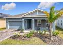 Charming single-Gathering home with a well-manicured front yard and a welcoming front porch with chairs at 338 Crestwind Dr, Daytona Beach, FL 32124