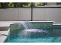 Tranquil waterfall feature spilling into the pool, creating a soothing ambiance for relaxation at 3415 Starbird Dr, Ocoee, FL 34761