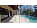 Inviting screened-in pool area with a generous patio, ideal for relaxation and recreation at 4421 Steed Ter, Winter Park, FL 32792